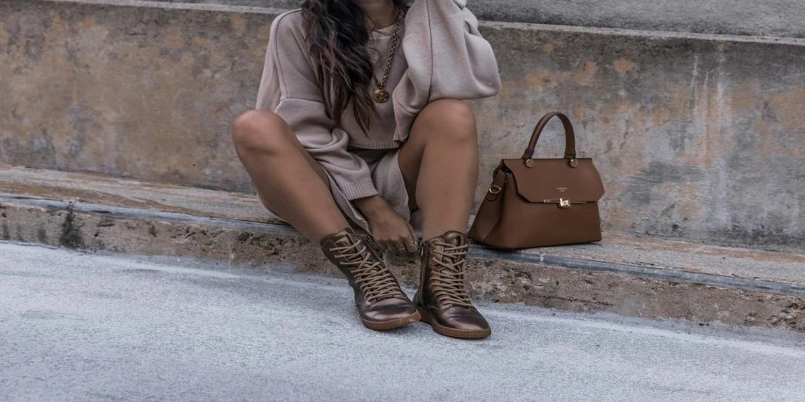 A-woman-wearing-brown-boots-with-a-brown-bag-beside-her.webp.jpg