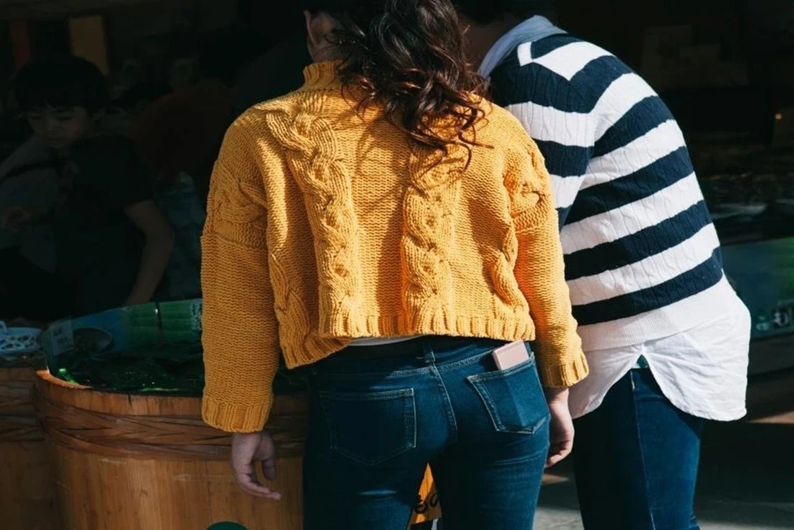 Two-women-wearing-yellow-and-striped-sweater.webp.jpg