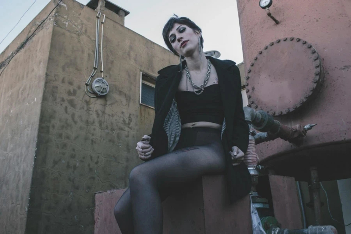 Woman-in-Black-Crop-Top-Sitting-on-Brown-Chair.webp.jpg