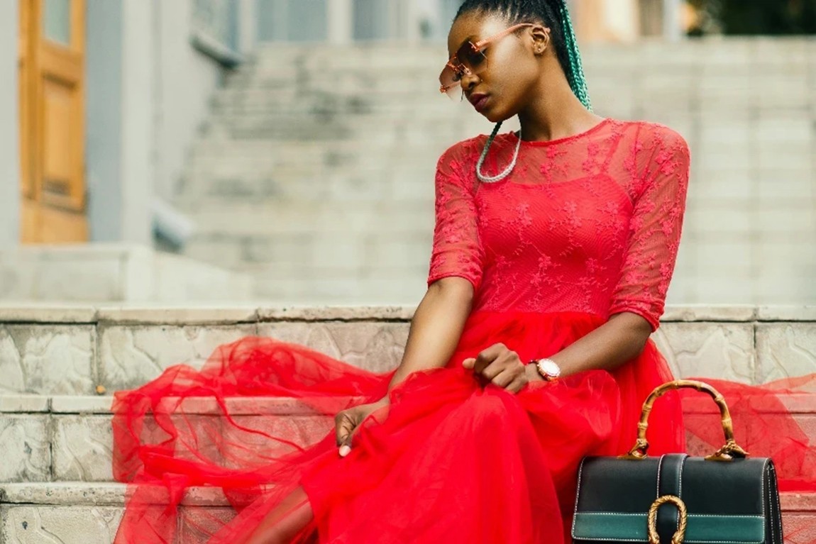 Woman-Wearing-Red-Long-sleeved-Dress-Near-Black-Leather-Bag-Sitting-on-Concrete-Stairs-Posing-for-Photoshoot-by-Godisable-Jacob.webp.jpg