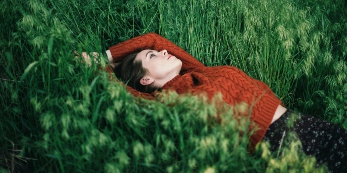 Woman-lying-on-grass.webp.jpg