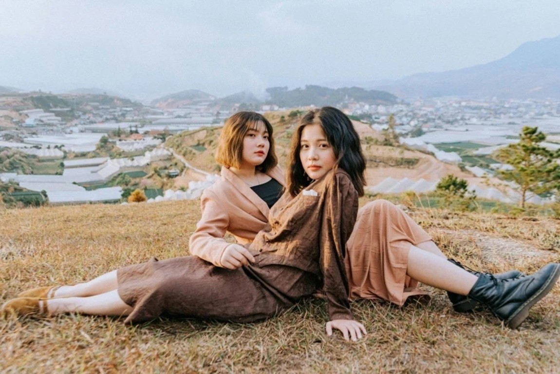 Two-women-sitting-on-hill.webp.jpg