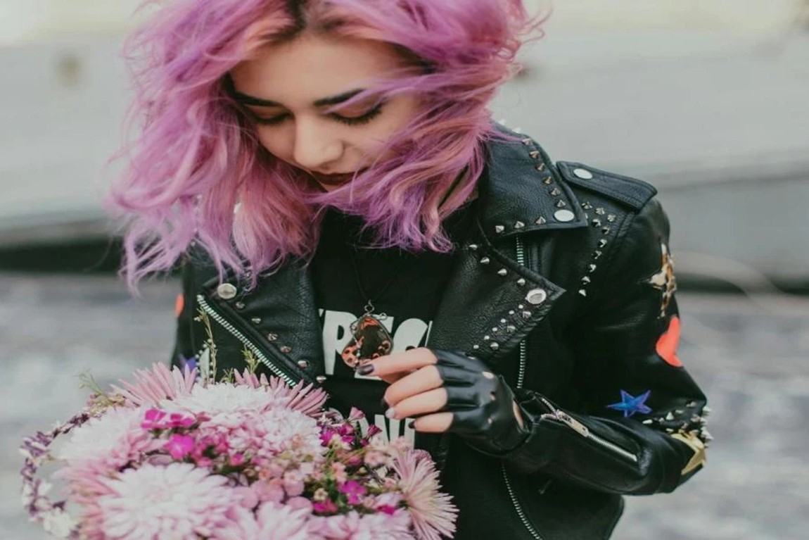 A-woman-with-pink-hair-wearing-a-studded-jacket.webp.jpg