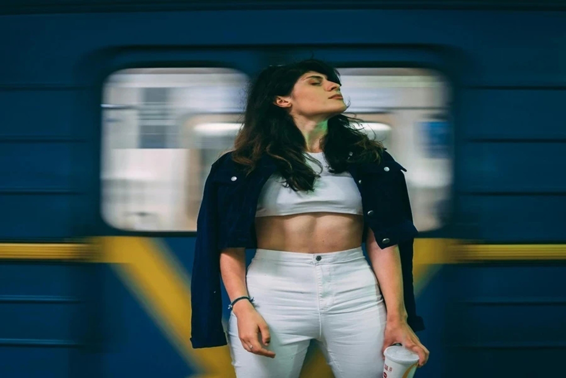 Woman-in-a-cropped-jacket-posing-in-subway-station.webp.jpg